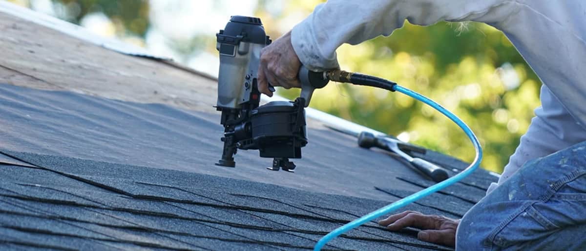 Capital City Roofing contractor installing roof shingles in Alpharetta
